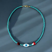 Load image into Gallery viewer, Detailed view of nacre evil eye, ladybug, and mushroom on the necklace.
