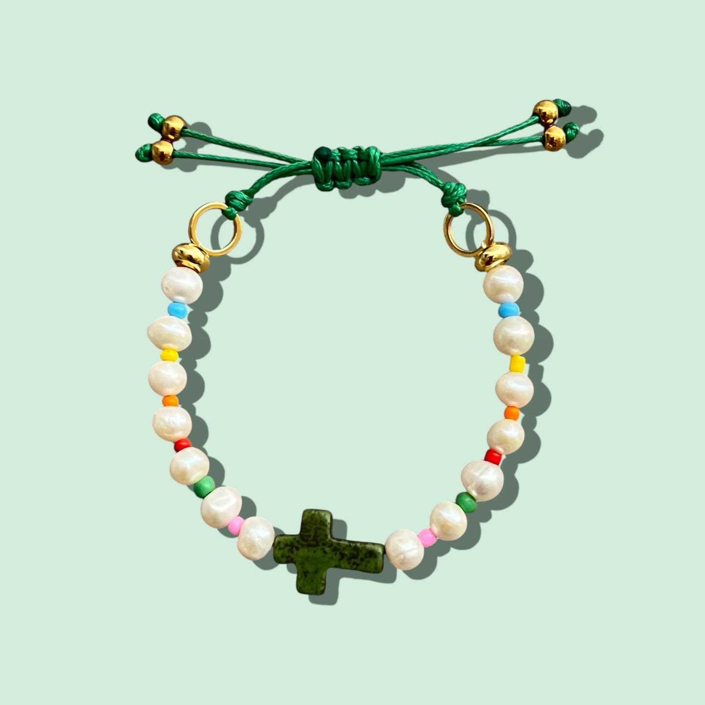 Close-up of a Freshwater Pearl Green Cross Bracelet with adjustable closure.