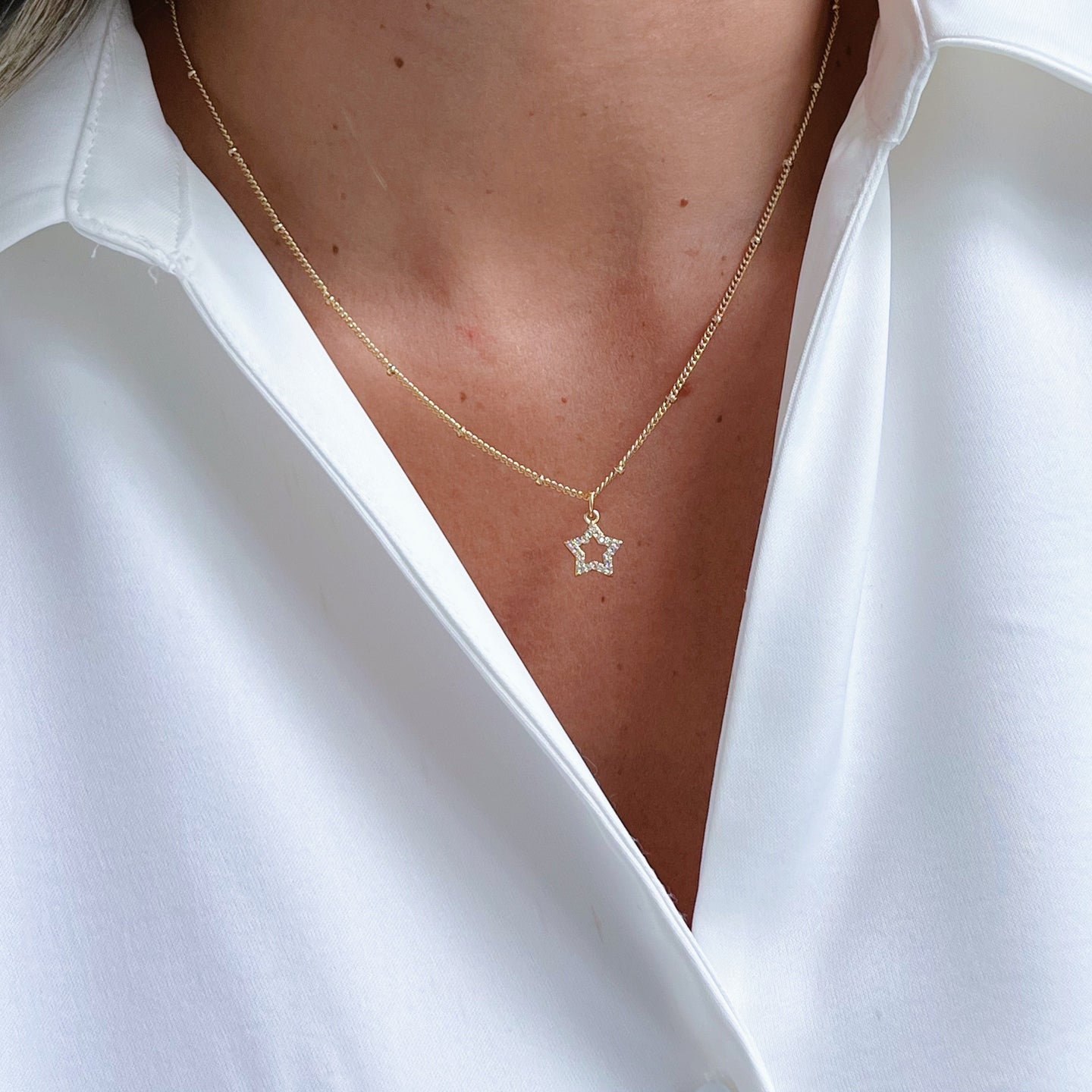 Tiny Star Necklace with a delicate cubic zirconia star pendant, perfect for layering or wearing solo.