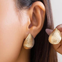 Load image into Gallery viewer, Model wearing silver textured drop earrings, stylish and elegant.
