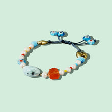 Load image into Gallery viewer, Bracelet laid flat, showcasing larimar, carnelian, and evil eye details.
