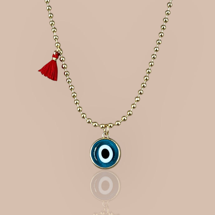 Blue beaded necklace featuring a Murano glass evil eye pendant set in 18k gold plated chain, symbolizing protection and elegance.