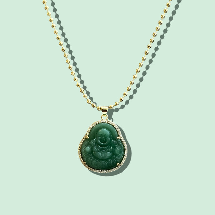 Close-up of Green Buddha pendant with CZ accents, gold plated over brass.