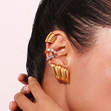 Load image into Gallery viewer, Model wearing gold wing earrings, showcasing bold style.

