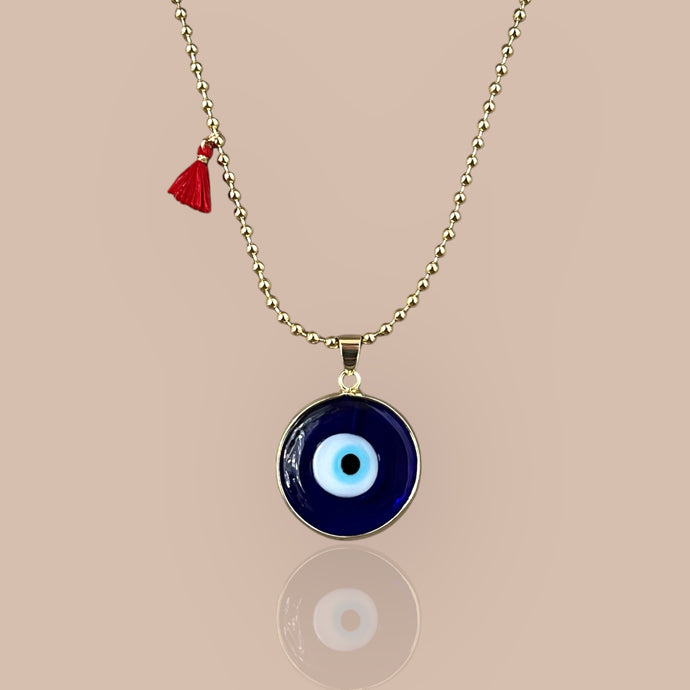 Blue beaded necklace featuring a Murano glass evil eye pendant set in 18k gold plated chain, symbolizing protection and elegance.