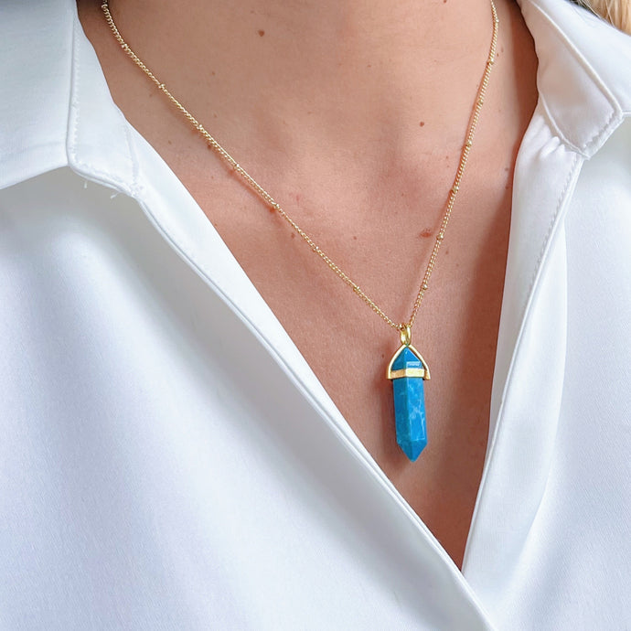 Turquoise Gemstone Pendulum Necklace featuring a vibrant turquoise gemstone, handcrafted with care. Unique and meaningful design.