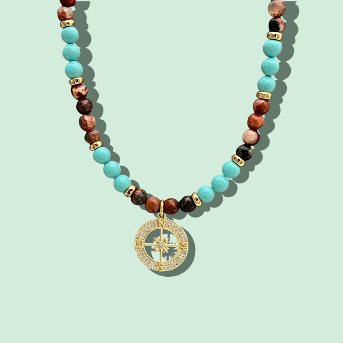 Close-up of Compass Beaded Necklace with turquoise and earth tones.