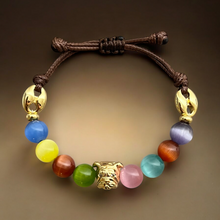 Load image into Gallery viewer, Close-up of a multicolor gemstone bracelet with a bulldog face charm, adjustable sliding closure.
