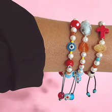 Load image into Gallery viewer, Model wearing colorful bracelet stacked with other jewelry.
