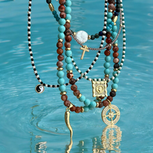 Load image into Gallery viewer, Close-up of the cross pendant with crystals.
