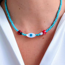 Load image into Gallery viewer, Detailed view of nacre evil eye, ladybug, and mushroom on the necklace.
