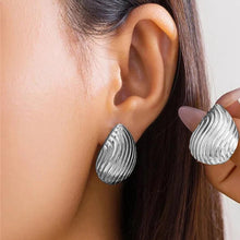 Load image into Gallery viewer, Model wearing silver textured drop earrings, stylish and elegant.
