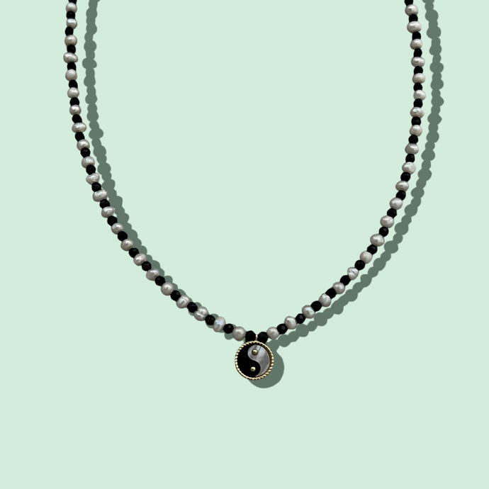 Close-up of Yin Yang pearl necklace with 8mm mother of pearl pendant.