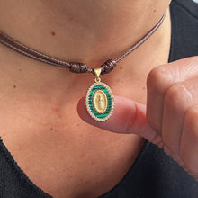 Load image into Gallery viewer, Close-up of malachite religious choker necklace with gold-tone charm and CZ accents
