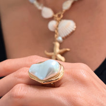 Load image into Gallery viewer, Model wearing Baroque pearl ring, adding a sophisticated touch to her outfit.
