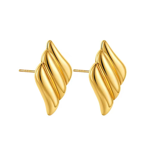 Close-up of statement gold wing earrings with a sleek finish.